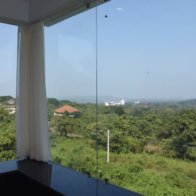 Devyani Villa Goa exterior view and lush landscape / Breathtaking valley view from luxury villa in Tiswadi / Villa terrace with BBQ grill and seating area