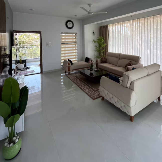 Spacious living room luxury villa Goa with modern decor / Comfortable 5-seater sofa lounge area Devyani Villa / Interior view of Devyani Villa living space
