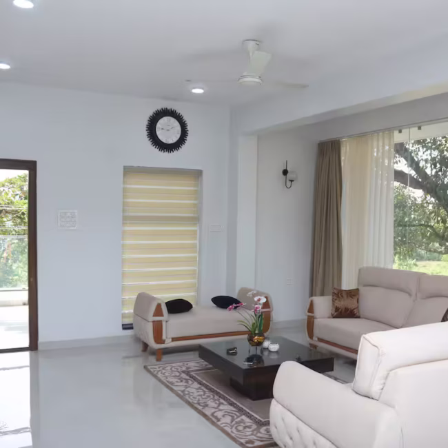 Spacious living room luxury villa Goa with modern decor / Comfortable 5-seater sofa lounge area Devyani Villa / Interior view of Devyani Villa living space