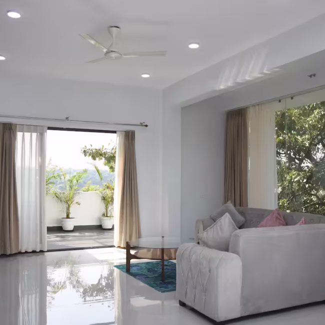 Spacious living room luxury villa Goa with modern decor / Comfortable 5-seater sofa lounge area Devyani Villa / Interior view of Devyani Villa living space