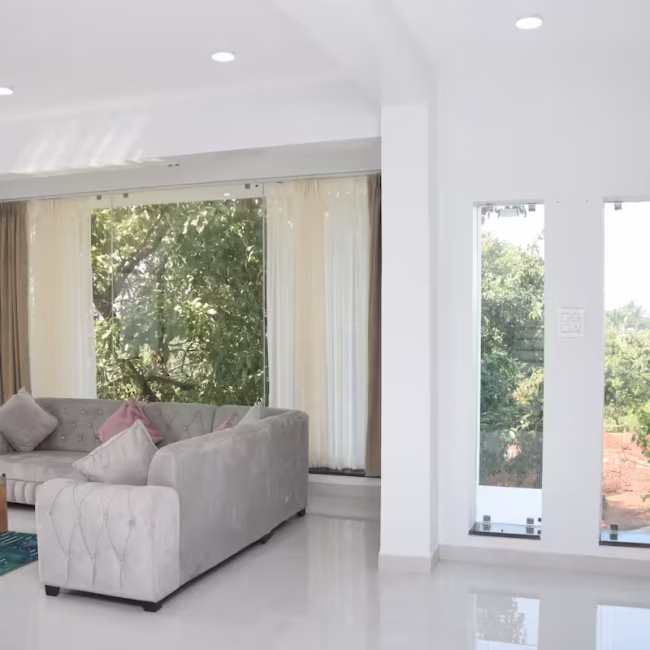 Spacious living room luxury villa Goa with modern decor / Comfortable 5-seater sofa lounge area Devyani Villa / Interior view of Devyani Villa living space